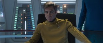 Movie still from “Star Trek Beyond” (2016), directed by Justin Lin – A man in a yellow shirt sitting in a chair; Close Up shot, Over the shoulder angle
