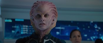 Movie still from “Star Trek Beyond” (2016), directed by Justin Lin – A woman in a pink and blue suit with a pink alien head; Close Up shot, Over the shoulder angle