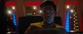 Movie still from “Star Trek Beyond” (2016), directed by Justin Lin – A man in a yellow shirt is sitting in a chair; Close Up shot, Over the shoulder angle