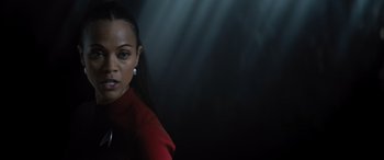 Movie still from “Star Trek Beyond” (2016), directed by Justin Lin – A woman in a red dress standing in front of a black background; Close Up shot, Low angle