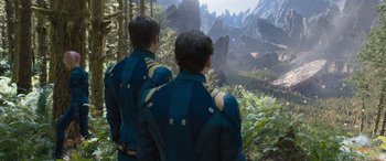Movie still from “Star Trek Beyond” (2016), directed by Justin Lin – Two men in blue and yellow jackets looking at a mountain; Extreme Wide shot, High angle