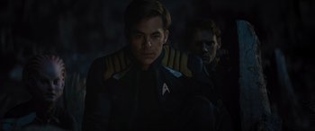 Movie still from “Star Trek Beyond” (2016), directed by Justin Lin – A man in a star trek uniform is looking at the camera; Medium shot, Over the shoulder angle
