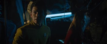 Movie still from “Star Trek Beyond” (2016), directed by Justin Lin – A man and a woman are standing next to each other in the dark; Medium shot, Over the shoulder angle