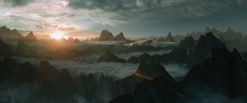 Movie still from “Star Trek Beyond” (2016), directed by Justin Lin – The sun is setting over a mountain range; Extreme Wide shot, High angle