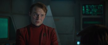 Movie still from “Star Trek Beyond” (2016), directed by Justin Lin – A man wearing a red shirt and a red shirt; Close Up shot, Over the shoulder angle