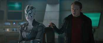 Movie still from “Star Trek Beyond” (2016), directed by Justin Lin – A man holding a television while another man stands next to it; Medium shot, Over the shoulder angle