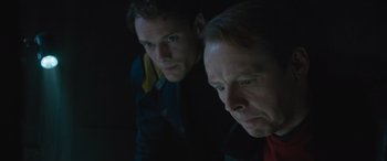 Movie still from “Star Trek Beyond” (2016), directed by Justin Lin – Two men looking at the camera in a dark room; Close Up shot, Low angle
