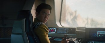 Movie still from “Star Trek Beyond” (2016), directed by Justin Lin – A man sitting in a car looking at the camera; Close Up shot, Over the shoulder angle