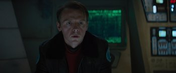 Movie still from “Star Trek Beyond” (2016), directed by Justin Lin – A man in a black jacket is looking at the camera; Close Up shot, Over the shoulder angle