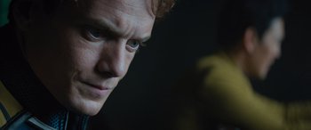 Movie still from “Star Trek Beyond” (2016), directed by Justin Lin – A man's face in a dark room; Close Up shot, Over the shoulder angle
