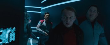 Movie still from “Star Trek Beyond” (2016), directed by Justin Lin – Two men standing next to each other in a dark room; Medium shot, Over the shoulder angle