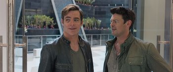 Movie still from “Star Trek Beyond” (2016), directed by Justin Lin – Two men standing next to each other in front of a building; Medium shot, Over the shoulder angle