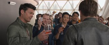 Movie still from “Star Trek Beyond” (2016), directed by Justin Lin – A group of people standing in a room holding drinks; Medium shot, Over the shoulder angle
