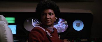 Movie still from “Star Trek II: The Wrath of Khan” (1982), directed by Nicholas Meyer – A woman in a star trek outfit looking at the camera; Close Up shot, Low angle