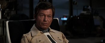 Movie still from “Star Trek II: The Wrath of Khan” (1982), directed by Nicholas Meyer – A person sitting in a chair; Close Up shot, Over the shoulder angle