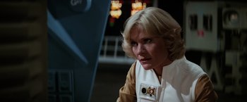Movie still from “Star Trek II: The Wrath of Khan” (1982), directed by Nicholas Meyer – An older woman with blonde hair wearing a star wars costume; Close Up shot, Low angle