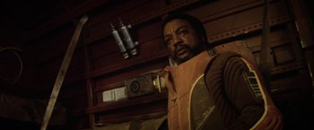 Movie still from “Star Trek II: The Wrath of Khan” (1982), directed by Nicholas Meyer – A man with a beard is standing next to a wall; Close Up shot, Low angle