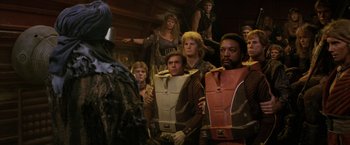 Movie still from “Star Trek II: The Wrath of Khan” (1982), directed by Nicholas Meyer – A group of people in costumes standing in a room; Medium shot, Over the shoulder angle