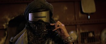 Movie still from “Star Trek II: The Wrath of Khan” (1982), directed by Nicholas Meyer – A person with a metal helmet on a cell phone; Close Up shot, Low angle