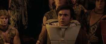 Movie still from “Star Trek II: The Wrath of Khan” (1982), directed by Nicholas Meyer – A man sitting in a chair with a woman standing next to him; Medium shot, Over the shoulder angle