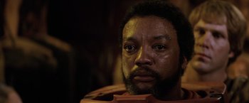 Movie still from “Star Trek II: The Wrath of Khan” (1982), directed by Nicholas Meyer – A person with a violin in a room; Close Up shot, Low angle