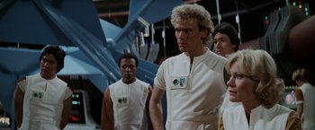 Movie still from “Star Trek II: The Wrath of Khan” (1982), directed by Nicholas Meyer – A group of men standing next to each other in a room; Medium shot, Over the shoulder angle