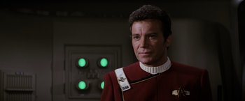 Movie still from “Star Trek II: The Wrath of Khan” (1982), directed by Nicholas Meyer – A person wearing a uniform; Close Up shot, Over the shoulder angle