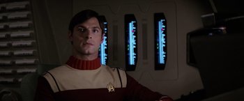 Movie still from “Star Trek II: The Wrath of Khan” (1982), directed by Nicholas Meyer – A man in a red and white uniform in front of a wall of lights; Close Up shot, Low angle