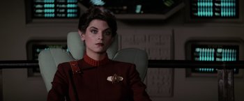 Movie still from “Star Trek II: The Wrath of Khan” (1982), directed by Nicholas Meyer – A woman sitting in a chair wearing a red uniform; Close Up shot, Over the shoulder angle