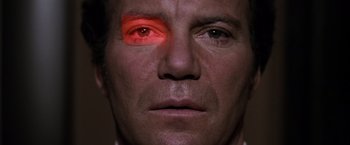 Movie still from “Star Trek II: The Wrath of Khan” (1982), directed by Nicholas Meyer – A person with a red light on their face; Extreme Close Up shot, Low angle