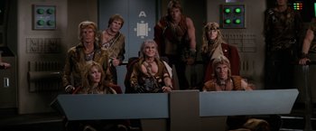 Movie still from “Star Trek II: The Wrath of Khan” (1982), directed by Nicholas Meyer – A group of people dressed in costumes sitting in a room; Medium shot, High angle