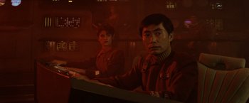 Movie still from “Star Trek II: The Wrath of Khan” (1982), directed by Nicholas Meyer – A man and a woman are sitting at a table; Medium shot, Low angle