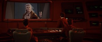Movie still from “Star Trek II: The Wrath of Khan” (1982), directed by Nicholas Meyer – A group of people sitting in front of a television; Medium shot, Over the shoulder angle