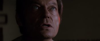 Movie still from “Star Trek II: The Wrath of Khan” (1982), directed by Nicholas Meyer – The face of a man in a dark room; Close Up shot, Low angle