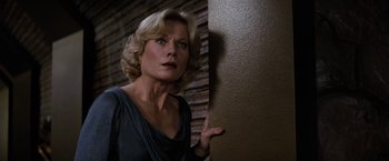 Movie still from “Star Trek II: The Wrath of Khan” (1982), directed by Nicholas Meyer – A woman is leaning against a wall with her hand on the side of the wall; Close Up shot, Low angle