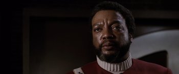 Movie still from “Star Trek II: The Wrath of Khan” (1982), directed by Nicholas Meyer – A person with a beard wearing a uniform; Close Up shot, Low angle
