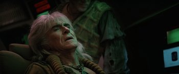 Movie still from “Star Trek II: The Wrath of Khan” (1982), directed by Nicholas Meyer – An old man with long white hair and a green outfit; Close Up shot, Over the shoulder angle