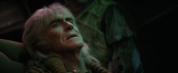 Movie still from “Star Trek II: The Wrath of Khan” (1982), directed by Nicholas Meyer – An old man with long white hair is looking up at the sky; Close Up shot, Over the shoulder angle