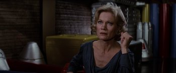 Movie still from “Star Trek II: The Wrath of Khan” (1982), directed by Nicholas Meyer – An older woman sitting at a table in front of a brick wall; Close Up shot, Over the shoulder angle