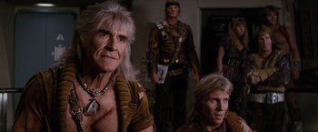 Movie still from “Star Trek II: The Wrath of Khan” (1982), directed by Nicholas Meyer – A group of people standing next to each other in a room; Medium shot, Over the shoulder angle