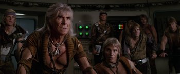 Movie still from “Star Trek II: The Wrath of Khan” (1982), directed by Nicholas Meyer – A group of people standing next to each other in a room; Medium shot, Over the shoulder angle