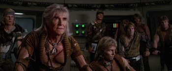Movie still from “Star Trek II: The Wrath of Khan” (1982), directed by Nicholas Meyer – A group of people in a room with lights on; Medium shot, Over the shoulder angle