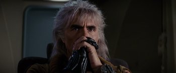 Movie still from “Star Trek II: The Wrath of Khan” (1982), directed by Nicholas Meyer – A man with grey hair and a leather glove; Close Up shot, Low angle