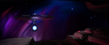 Movie still from “Star Trek II: The Wrath of Khan” (1982), directed by Nicholas Meyer – A star trek ship in a room lit by a blue light; Extreme Wide shot, Low angle