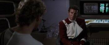 Movie still from “Star Trek II: The Wrath of Khan” (1982), directed by Nicholas Meyer – A man sitting in front of another man in a room; Medium shot, Over the shoulder angle