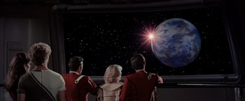 Movie still from “Star Trek II: The Wrath of Khan” (1982), directed by Nicholas Meyer – A group of people standing next to each other in front of a screen; Wide shot, Over the shoulder angle