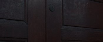 Movie still from “Censor” (2021), directed by Prano Bailey-Bond – The door of a dark room; Extreme Close Up shot, High angle