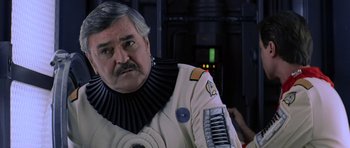 Movie still from “Star Trek III: The Search for Spock” (1984), directed by Leonard Nimoy – An older man in a white space suit; Close Up shot, Over the shoulder angle