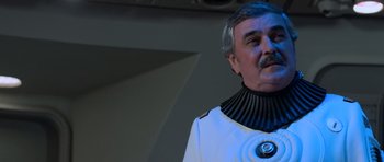 Movie still from “Star Trek III: The Search for Spock” (1984), directed by Leonard Nimoy – An older man wearing a white shirt and a black collar; Close Up shot, Over the shoulder angle