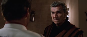 Movie still from “Star Trek III: The Search for Spock” (1984), directed by Leonard Nimoy – A man in a black shirt is looking at another man; Close Up shot, Over the shoulder angle